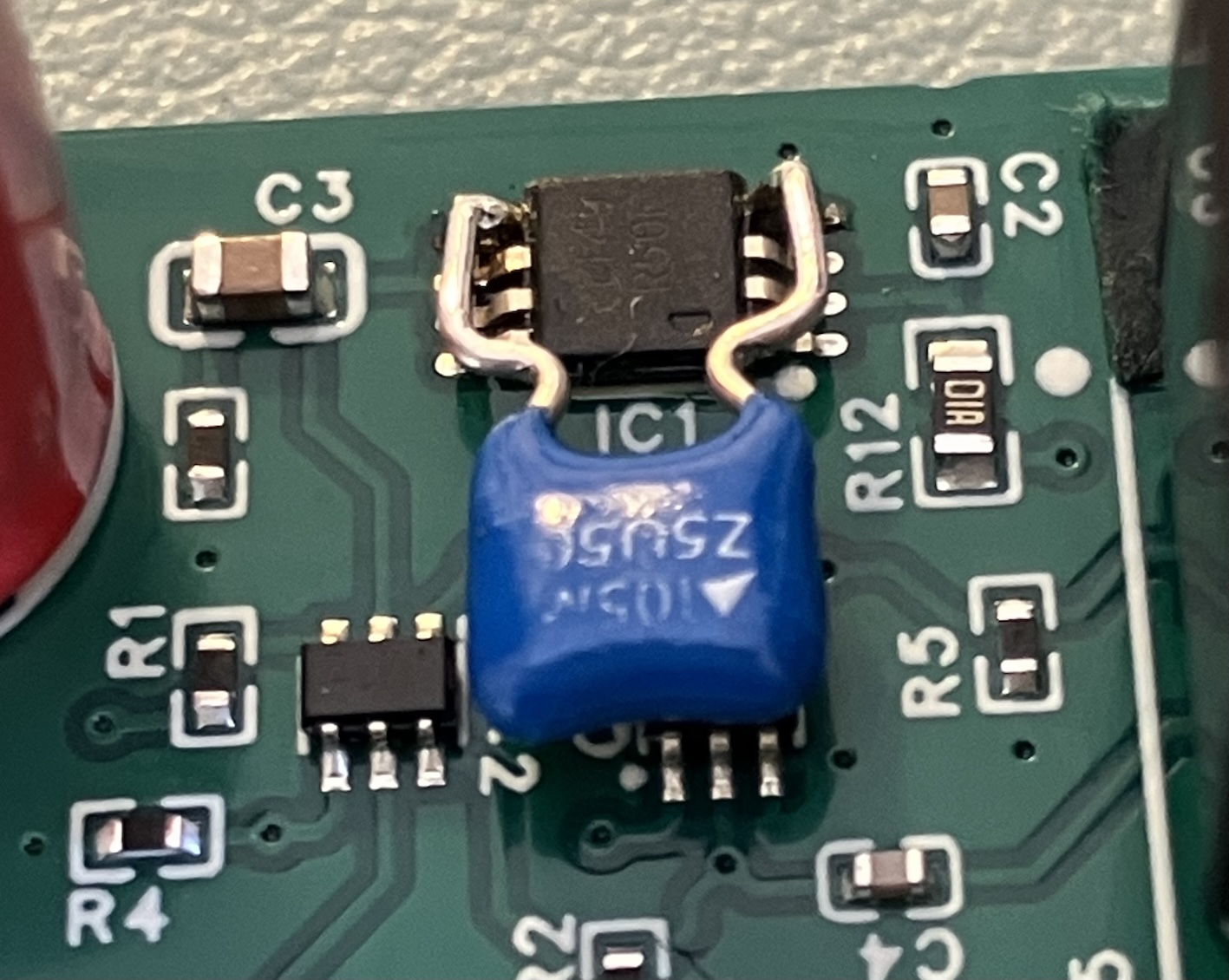 The 1 µF capacitor fitted as a through-hole part between pin 5 and the ground pin of the voltage reference, on a production board